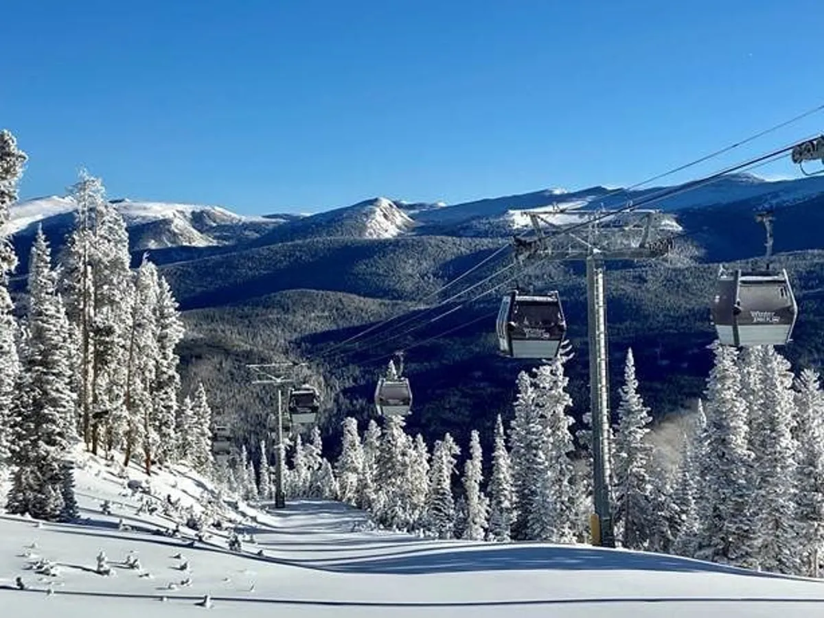 A panoramic exterior view featuring a ski lift ascending snow-covered slopes, set against a dramatic mountain landscape. The scene brims with possibilities for outdoor adventure, from skiing and snowboarding to snowshoeing and nature walks, all beneath an expansive sky.